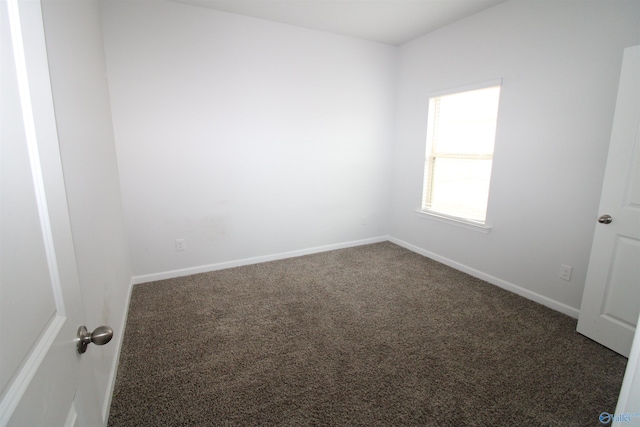 empty room featuring dark colored carpet