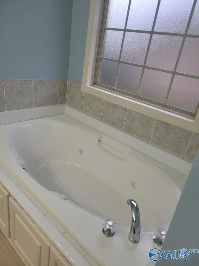 full bathroom with a jetted tub