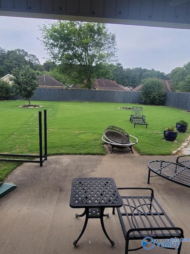 surrounding community featuring an outdoor fire pit, a patio area, a yard, and a fenced backyard