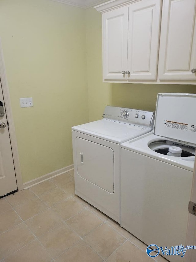 laundry room featuring cabinet space, independent washer and dryer, baseboards, and light tile patterned floors