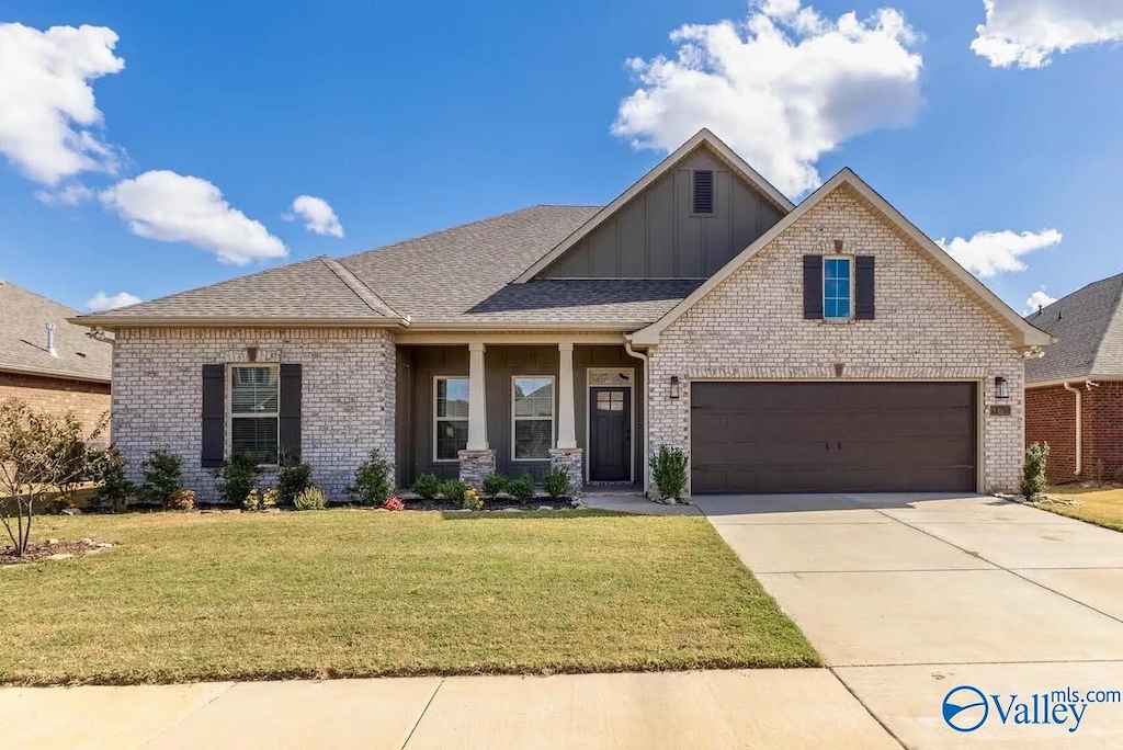 craftsman inspired home featuring a front yard and a garage