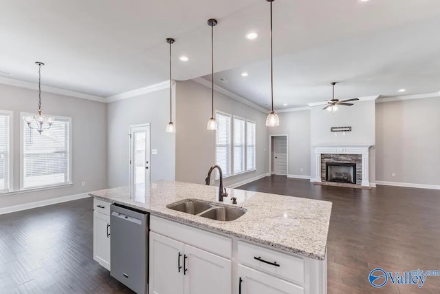 kitchen featuring dark hardwood / wood-style floors, sink, white cabinetry, a stone fireplace, and stainless steel dishwasher