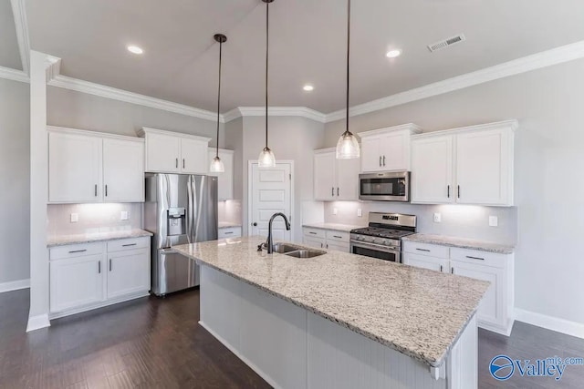 kitchen featuring appliances with stainless steel finishes, white cabinetry, dark hardwood / wood-style floors, a center island with sink, and sink