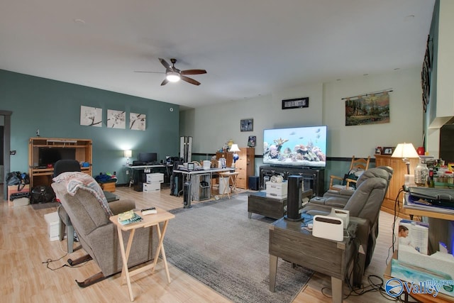 living room with light hardwood / wood-style flooring and ceiling fan