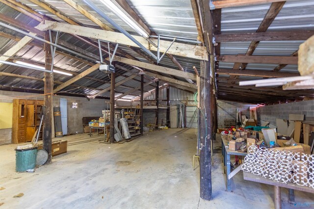 interior space featuring lofted ceiling and concrete flooring