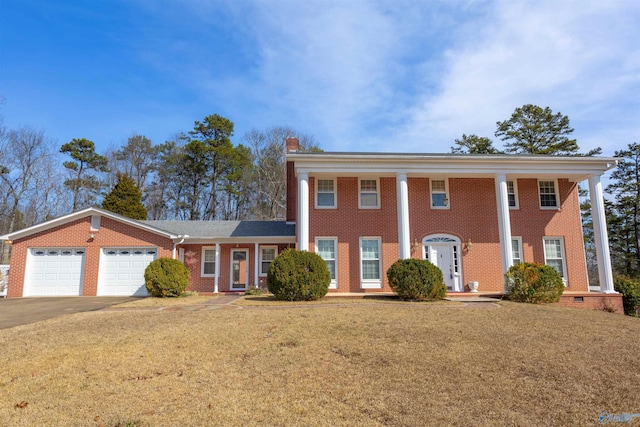 greek revival house featuring a garage and a front yard