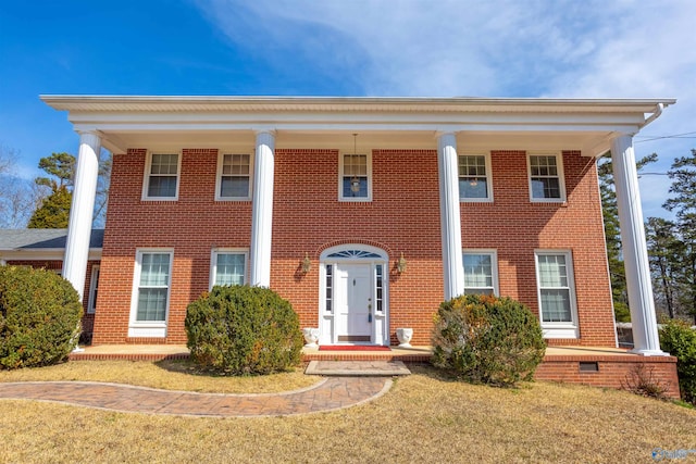 neoclassical / greek revival house featuring a front lawn and covered porch