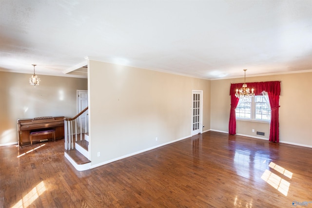 unfurnished room featuring dark wood-type flooring and a notable chandelier