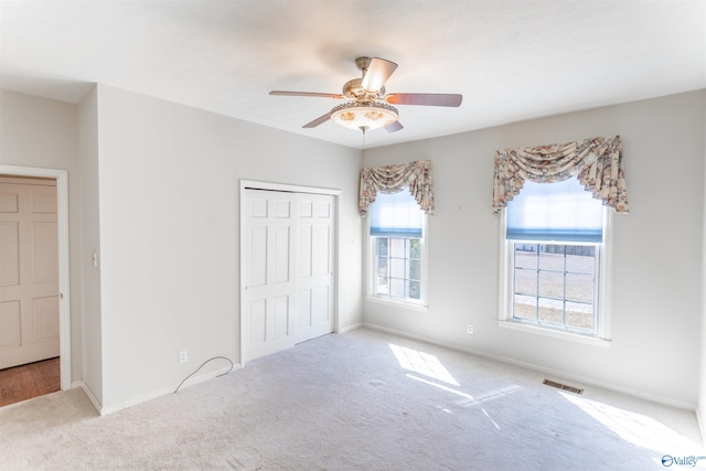 unfurnished bedroom featuring a closet, ceiling fan, and carpet floors