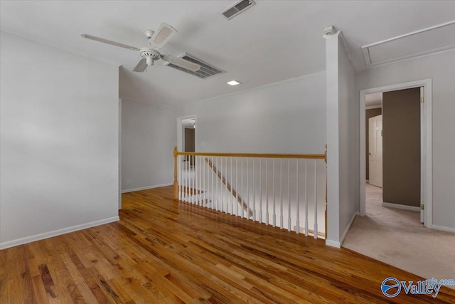 empty room featuring ornamental molding, ceiling fan, and light hardwood / wood-style flooring