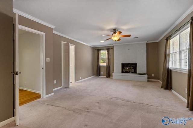 unfurnished living room with light carpet, a fireplace, ornamental molding, and ceiling fan