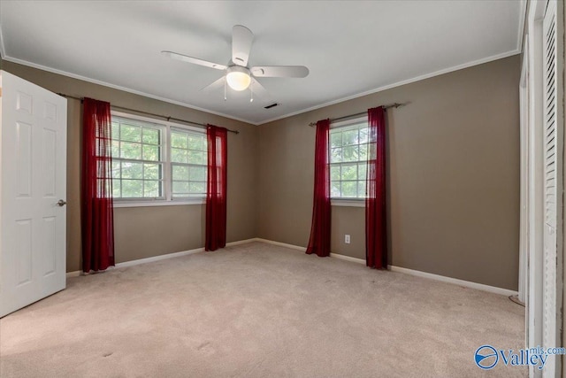 unfurnished bedroom featuring ceiling fan, ornamental molding, and light carpet