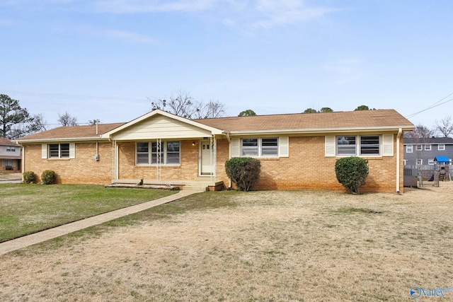 single story home featuring brick siding and a front yard