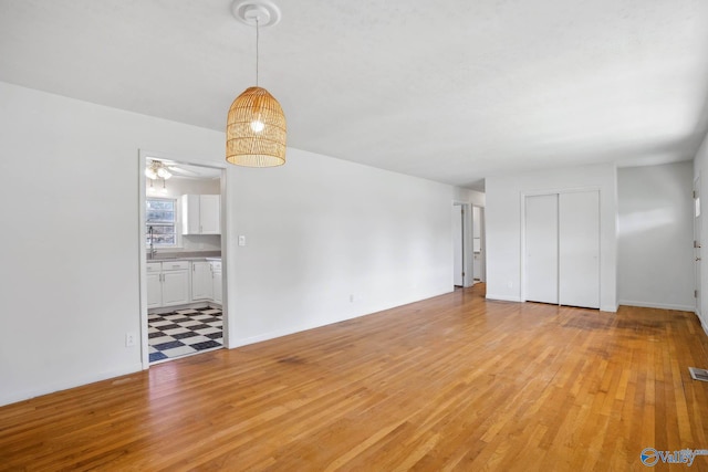 unfurnished living room featuring light wood-style flooring