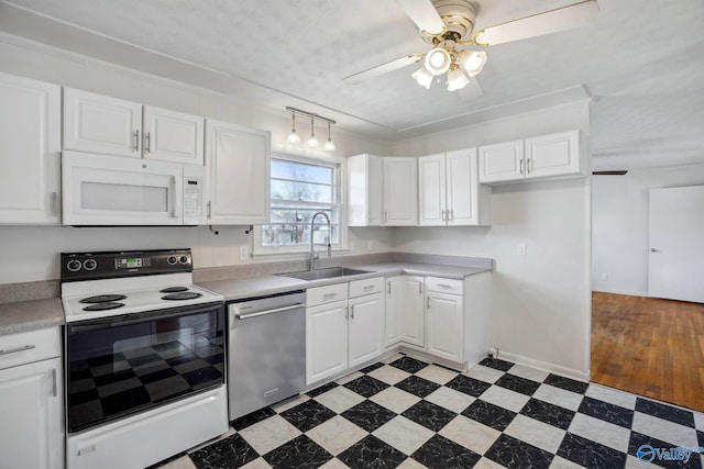 kitchen featuring white microwave, white cabinetry, electric stove, light countertops, and stainless steel dishwasher