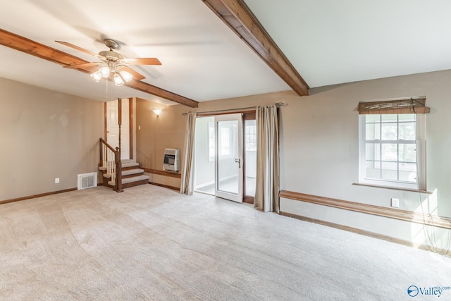 unfurnished living room featuring heating unit, visible vents, carpet floors, ceiling fan, and beamed ceiling