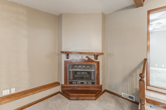 details with visible vents, baseboards, carpet, and a fireplace