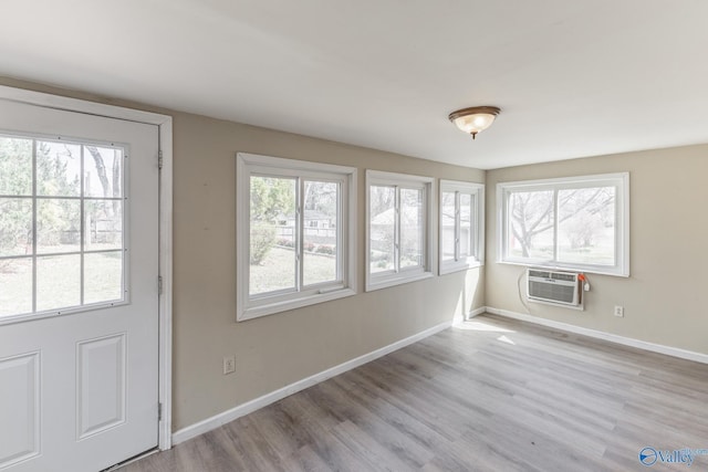 interior space with a wealth of natural light and a wall unit AC