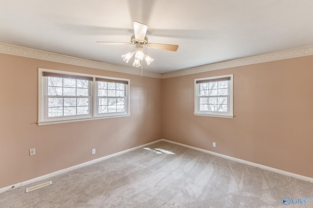 spare room featuring a ceiling fan, carpet flooring, visible vents, and baseboards