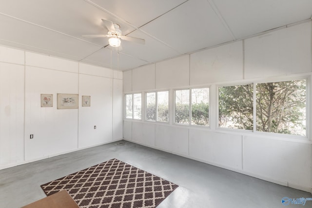 unfurnished sunroom with ceiling fan