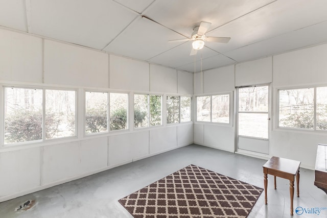 unfurnished sunroom with ceiling fan