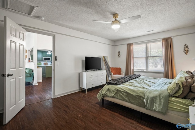 bedroom featuring a textured ceiling, ceiling fan, and wood finished floors