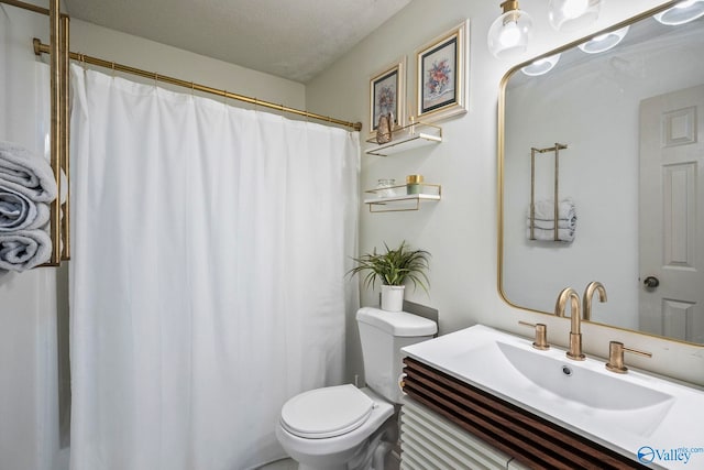 bathroom featuring curtained shower, toilet, vanity, and a textured ceiling