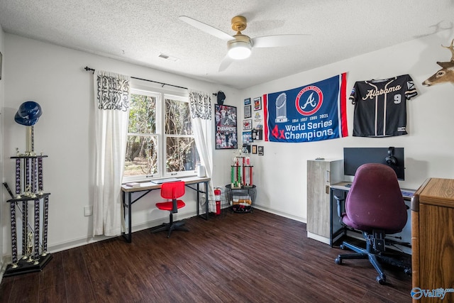 office area with a ceiling fan, baseboards, wood finished floors, visible vents, and a textured ceiling