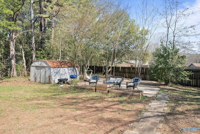 view of yard featuring an outbuilding, a shed, and fence