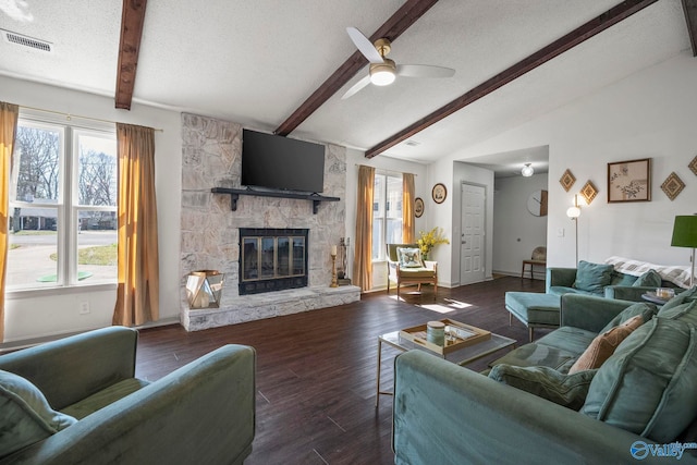 living room with wood finished floors, visible vents, vaulted ceiling with beams, ceiling fan, and a textured ceiling