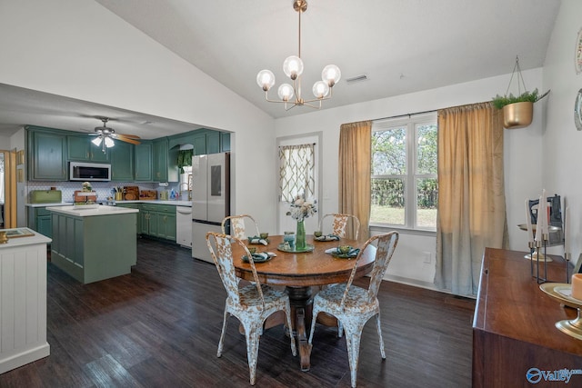 dining room with visible vents, ceiling fan with notable chandelier, dark wood-style floors, and vaulted ceiling