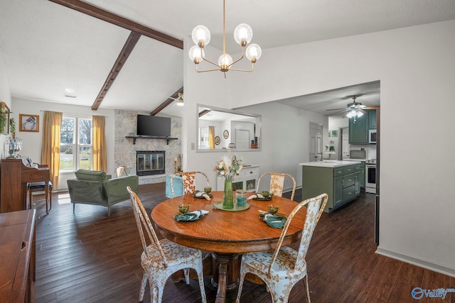 dining room with vaulted ceiling with beams, baseboards, a stone fireplace, ceiling fan with notable chandelier, and dark wood-style flooring