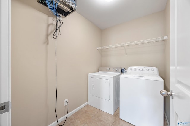 laundry area with washing machine and dryer and light tile patterned flooring