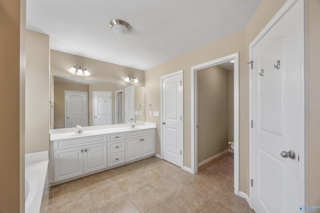 bathroom featuring vanity, a bath, and tile patterned flooring