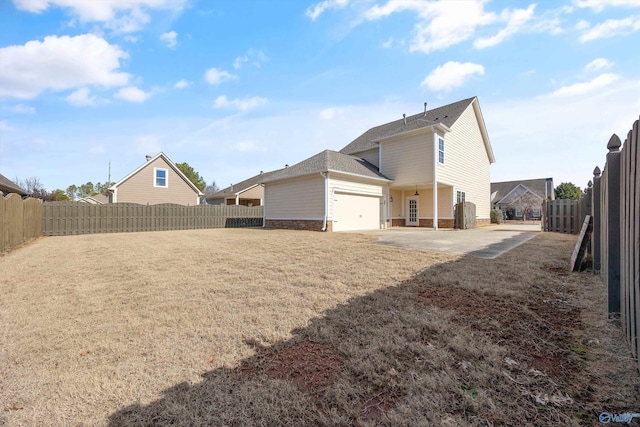 rear view of property with a garage