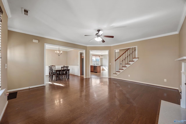 unfurnished living room with crown molding, dark wood-type flooring, and ceiling fan with notable chandelier