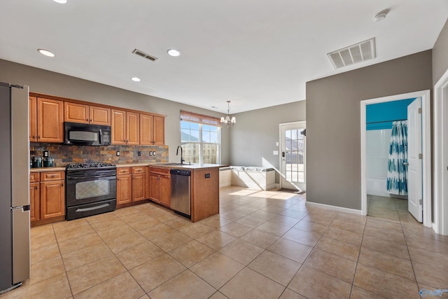 kitchen with pendant lighting, sink, tasteful backsplash, black appliances, and kitchen peninsula