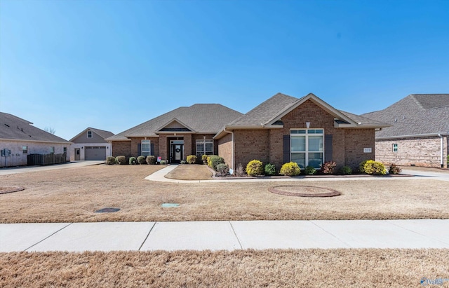 view of front of house with brick siding, concrete driveway, a garage, and a shingled roof