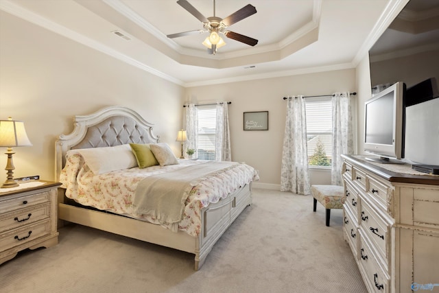 bedroom with visible vents, crown molding, ceiling fan, light colored carpet, and a raised ceiling