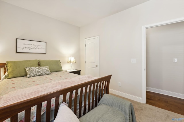 carpeted bedroom featuring baseboards