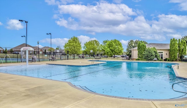 pool featuring a patio area and fence