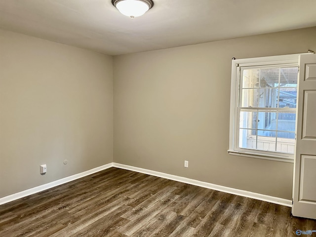 empty room featuring dark hardwood / wood-style flooring