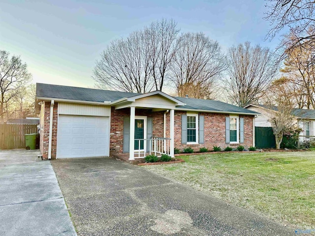 single story home featuring a front lawn and a garage