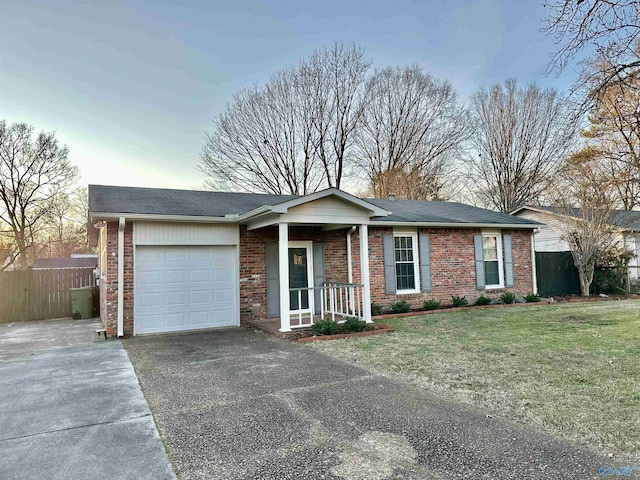 ranch-style home with a front yard and a garage