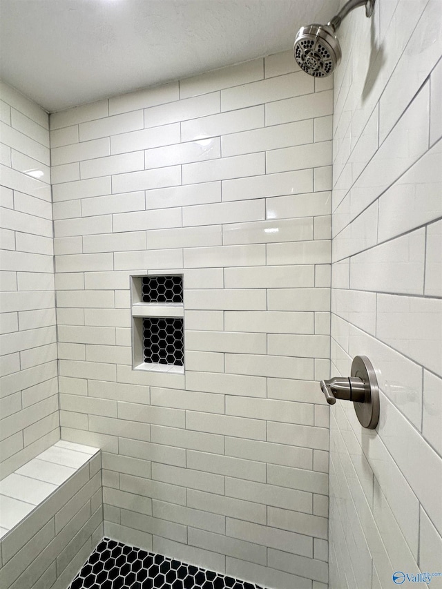 bathroom with tiled shower