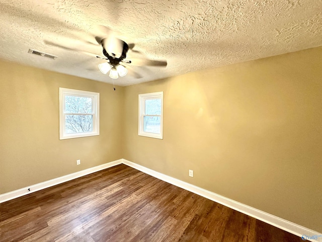 empty room featuring hardwood / wood-style floors, a textured ceiling, and ceiling fan