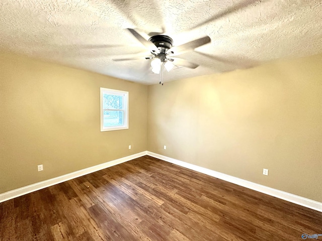 empty room with ceiling fan, wood-type flooring, and a textured ceiling