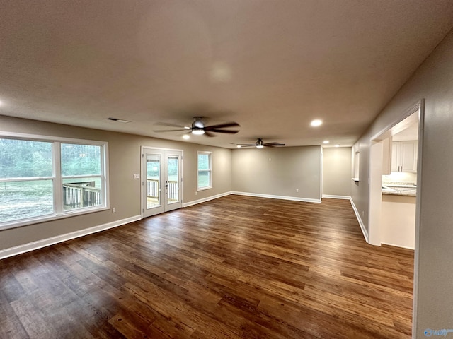 spare room featuring visible vents, baseboards, dark wood-style floors, and french doors