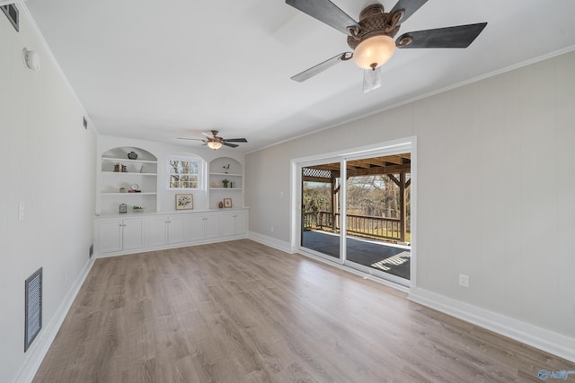 unfurnished living room with built in features, light wood-type flooring, visible vents, and ornamental molding