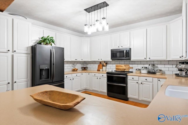 kitchen featuring decorative backsplash, white cabinetry, stainless steel appliances, and hanging light fixtures